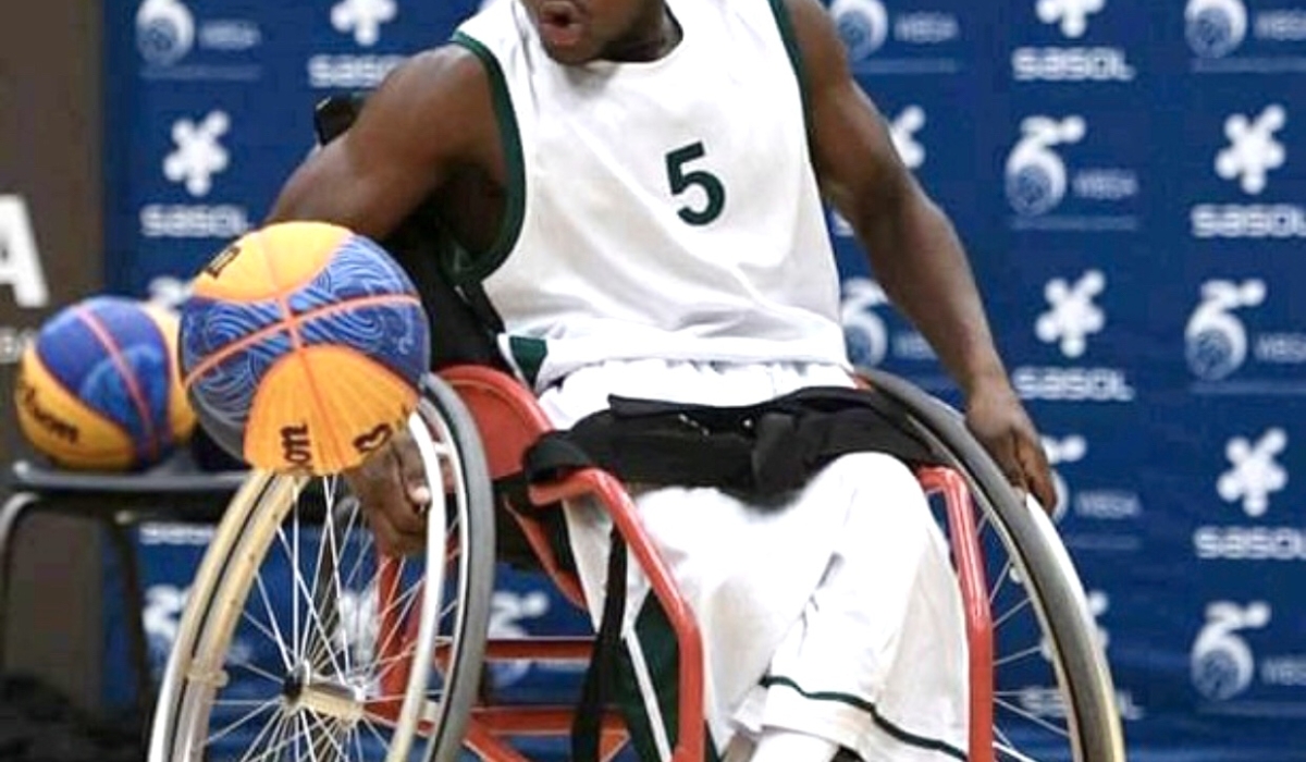 Munyaneza applies speed on the wheelchair to grab the ball.