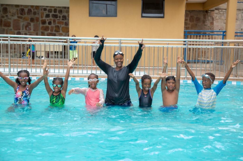 Muyumbukazi  with some of her students after  swimming training.