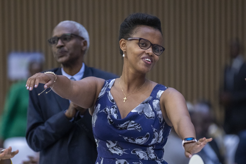 Patricie Uwase, the Minister of State in the Ministry of Infrastructure dances during  a praise and worship session to the 28th annual National Prayer Breakfast at Kigali Convention Centre on January 15. All photos by Olivier Mugwiza