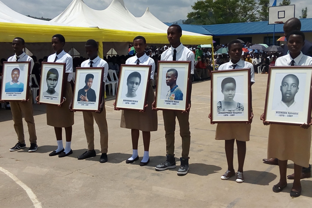 Students with portraits of heroes of Nyange during a commemoration event at Ecole Secondaire de Nyange   in Ngororero District   . Students were killed on 18 March 1997, when infiltrators attacked the school, killed a watchman and opened fire indiscriminately, then six students died on the spot and about 40 others sustained injuries. File