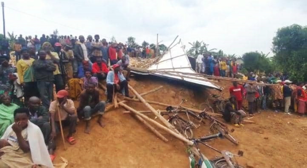 Rusororo residents at a scene of a fatal accident where a maize drying shelter collapsed in Rusororo, killing 11 people while more than 30 were critically injured, on Friday, February 3. Courtesy