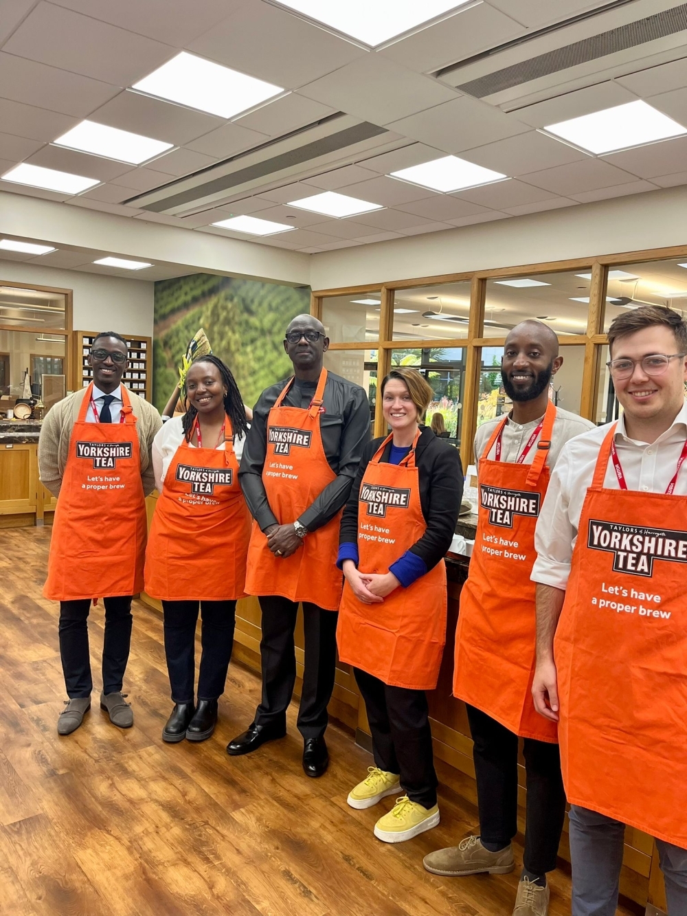 The High Commission team and Johnston Busingye, Rwanda&#039;s High Commissioner to the UK, pose for a photo at Taylors of Harrogate, as they visited some of the UK’s most prestigious and popular importers and retailers of Rwandan tea .