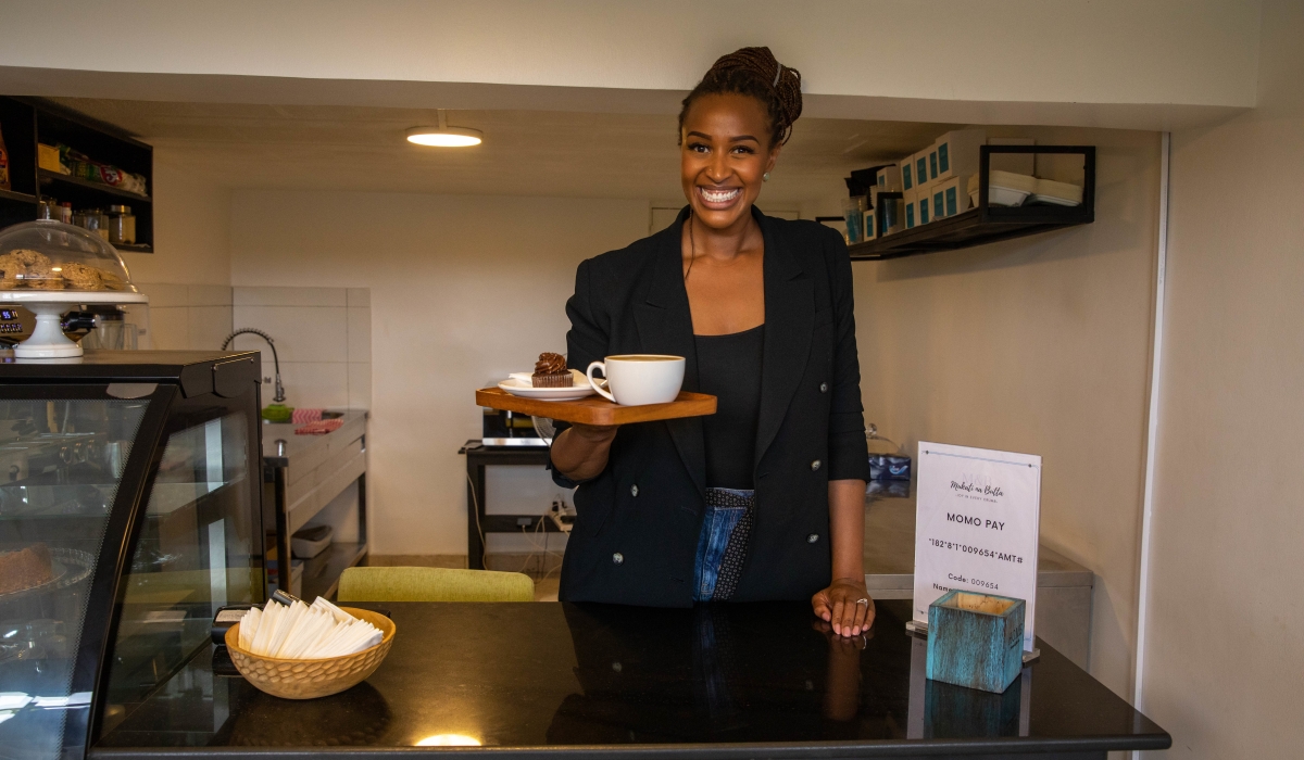 Erica Mbanda serving Coffee in her coffee shop in Kigali. 