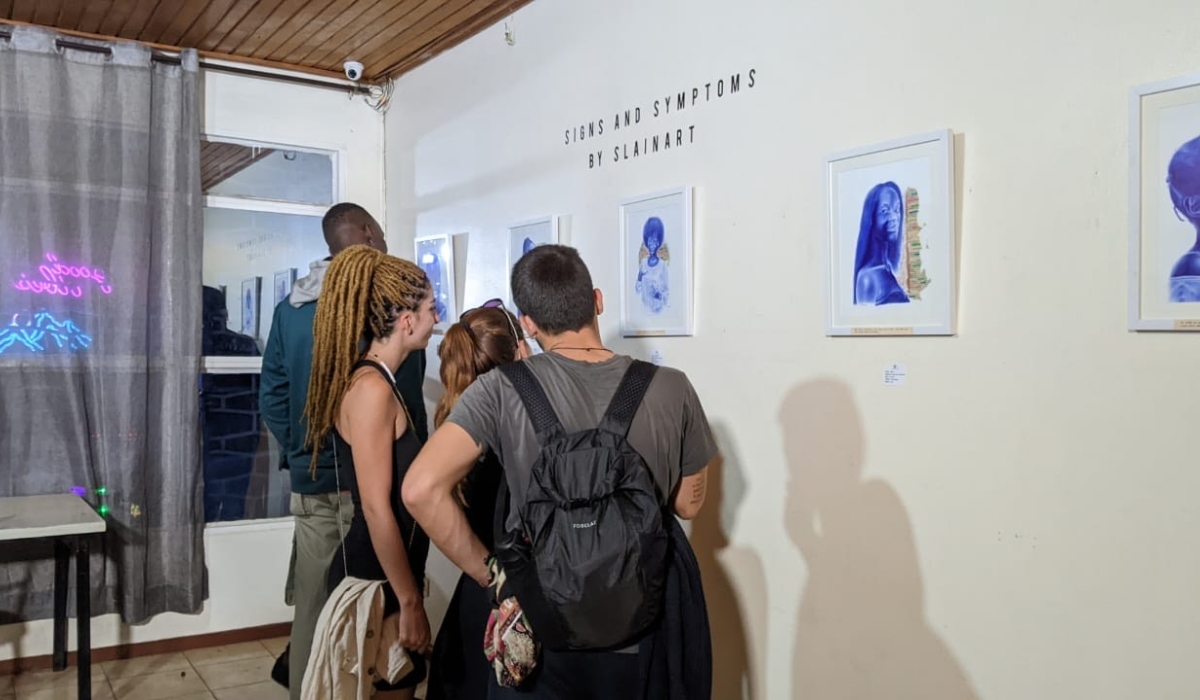 Gislain Mugisha (below left) and some of the guests that attended the art exhibition. Courtesy photo.