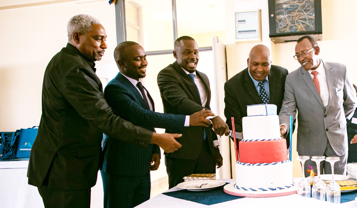 Officials cut a cake at the launch of the memoir titled “Mountain Meets Land of a Thousand Hills&#039; on Friday ,February 10. Photos by Dan Gatsinzi