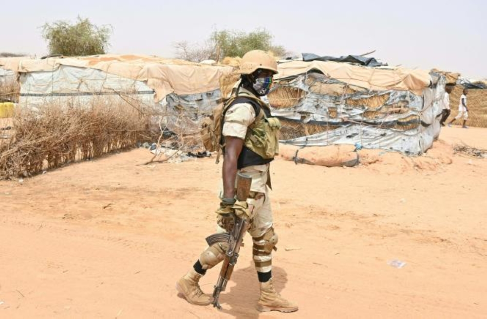 A Nigerien soldier patrols at an internally displaced persons (IDP) camp in Ouallam, Niger. At least ten soldiers were killed in an ambush by a group of "armed terrorists" in southwestern Niger, the ministry of defence said on February 11. Photo by AFP