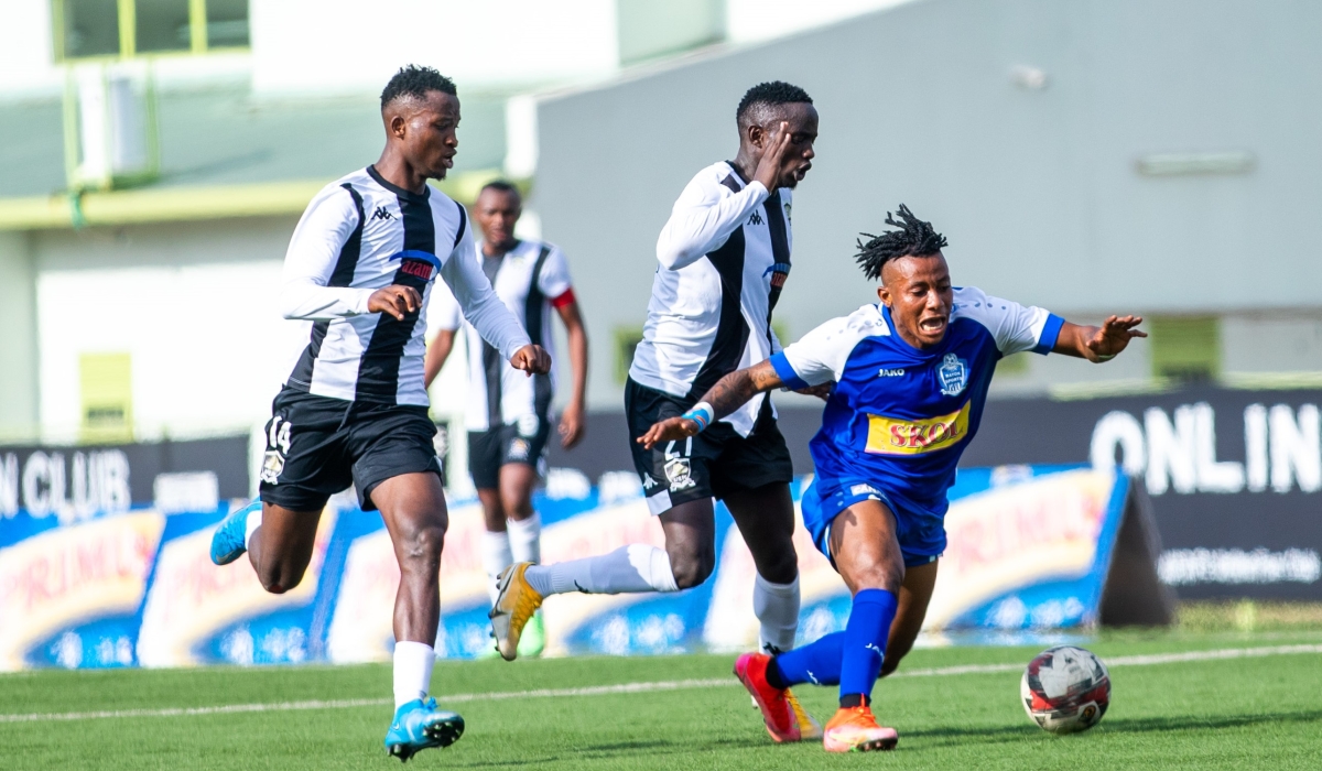 Rayon Sports player Samuel wins the ball against APR FC players during a past derby at Kigali Stadium. The two rivals will face a derby at Huye stadium. Photo by Olivier Mugwiza