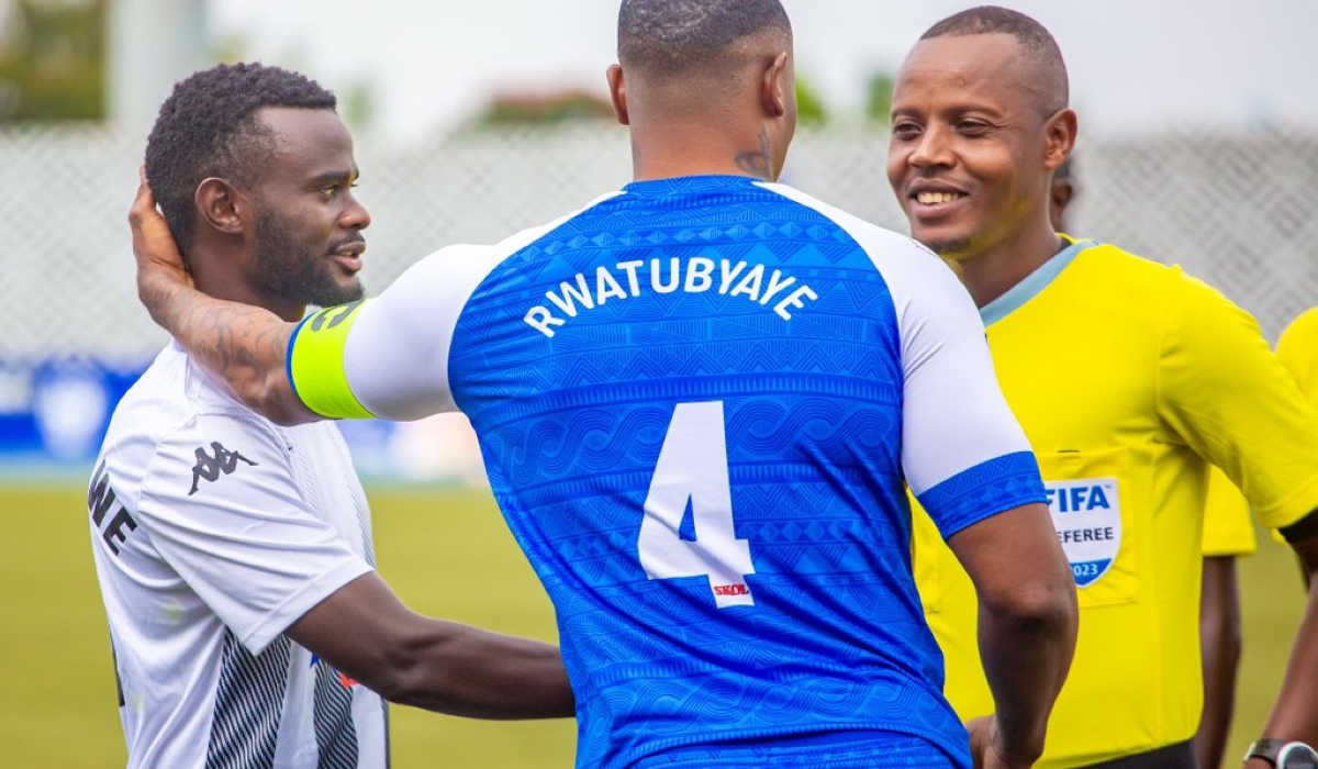 Rayon Sports Skipper, defender Abdul Rwatubyaye chats with referee Nsoro before the match against APR FC. The Blues shocked the rivals with a 1-0 win at Huye Stadium. Courtesy
