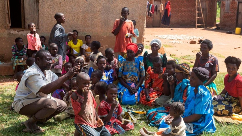 Musa Hasahya interacts with some of his wives, children and grandchildren outside their family home. He is struggling to provide for his 12 wives, 102 children and 578 grandchildren. PHOTO | BADRU KATUMBA | AFP