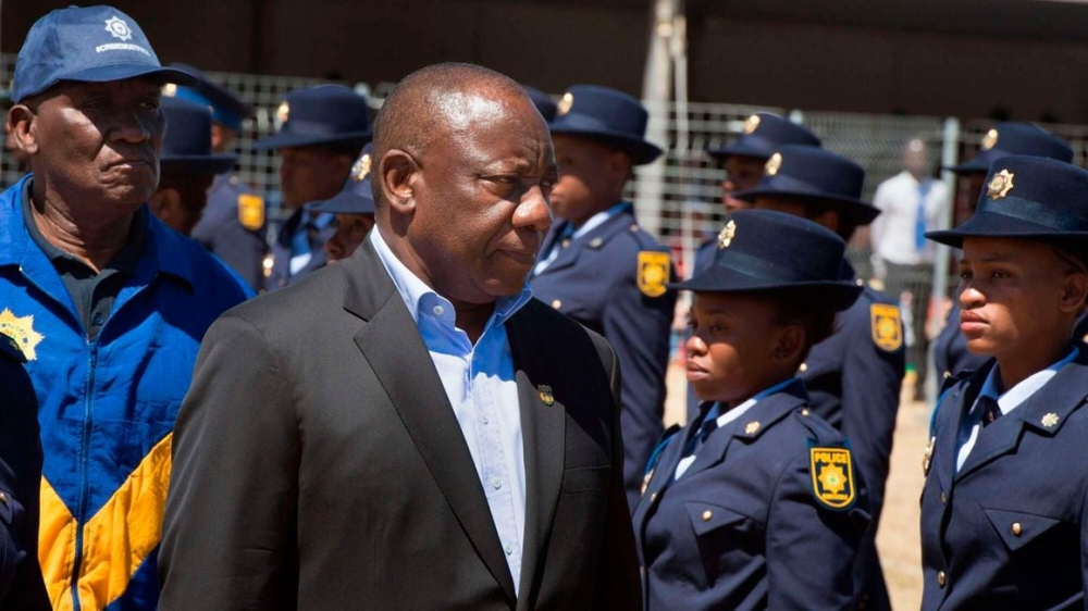 South-Africa&#039;s President Cyril Ramaphosa (R) and Police Minister Bheki Cele inspecting a guard of honour. Crime statistics released on February 17, 2023 by South Africa police minister revealed rape and murder cases increased significantly in the country in just three months. Photo by AFP

