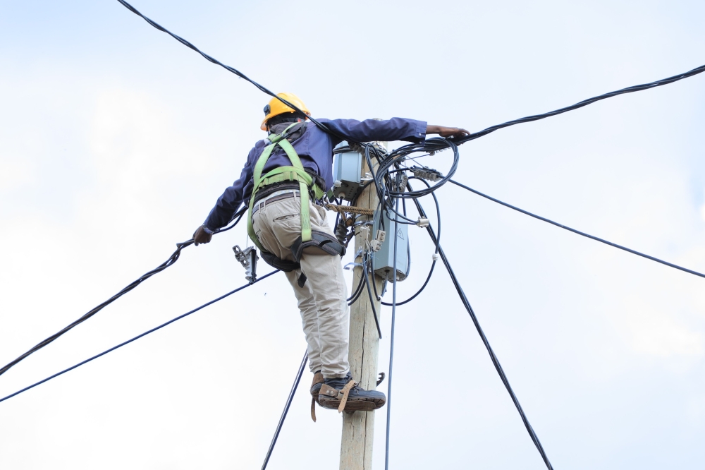 A technician during the electricity supply activities  in Gicumbi District. File