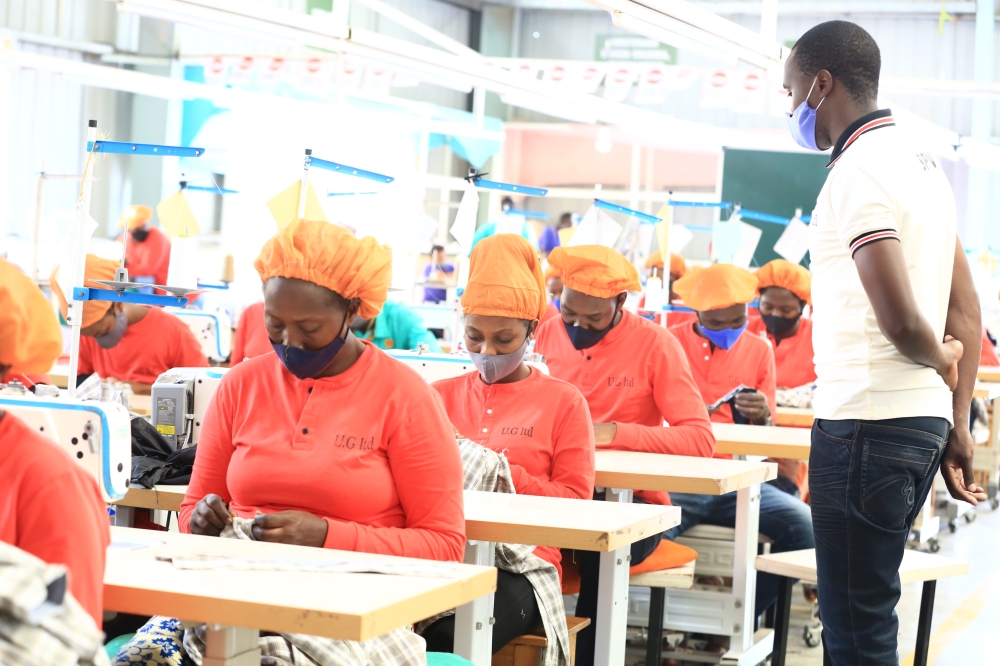 A supervisor inspects how workers do their tasks at Ufaco garment factory at Kigali Special Economic Zone. Sam Ngenda