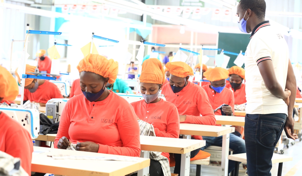 A supervisor inspects how workers do their tasks at Ufaco garment factory at Kigali Special Economic Zone. Sam Ngenda