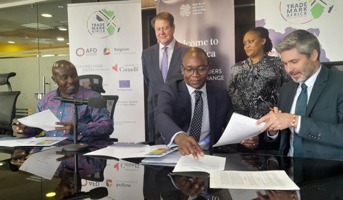Trademark Africa CEO David Beer (right) signs an MoU with Tony Blair Institute Africa Managing Director Rishon Chimboza (centre) and Trade Catalyst Africa Chairman Patrick Obath (left) in Nairobi Kenya on February 27, 2023. Photo by NMG