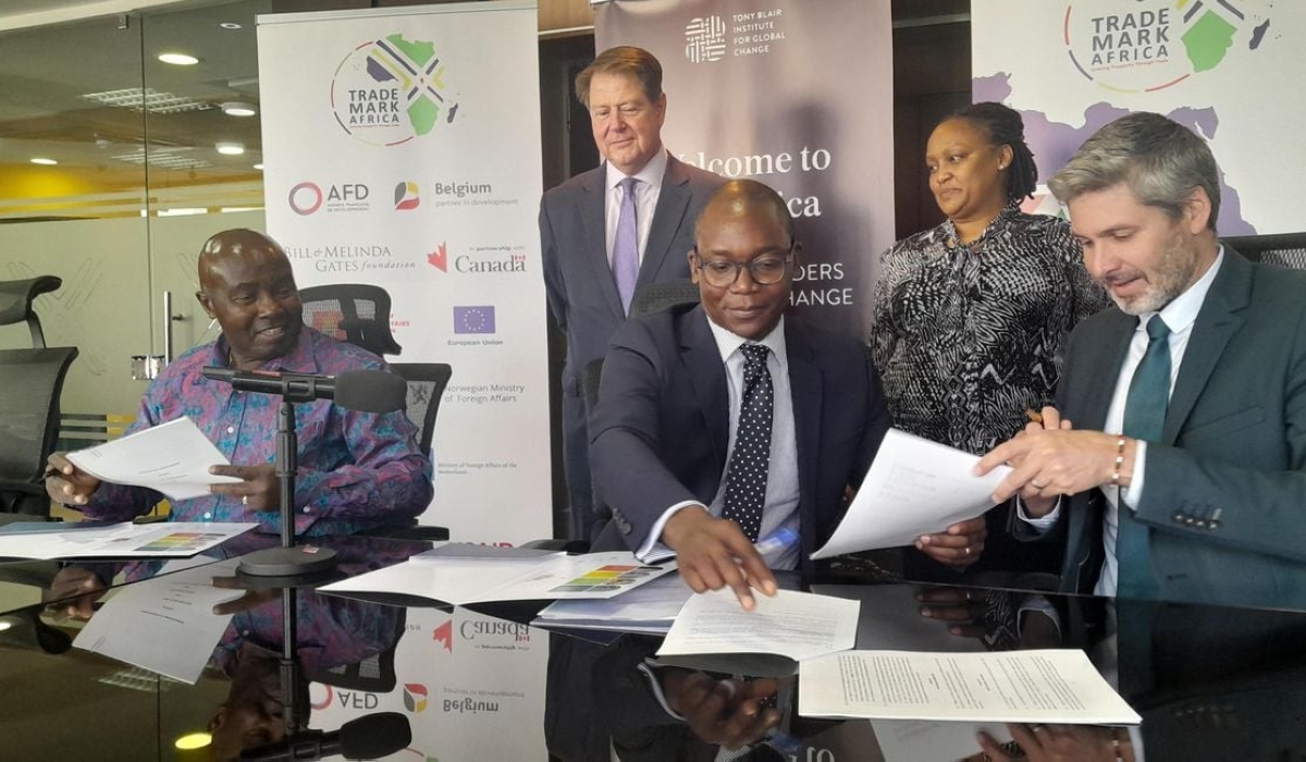 Trademark Africa CEO David Beer (right) signs an MoU with Tony Blair Institute Africa Managing Director Rishon Chimboza (centre) and Trade Catalyst Africa Chairman Patrick Obath (left) in Nairobi Kenya on February 27, 2023. Photo by NMG