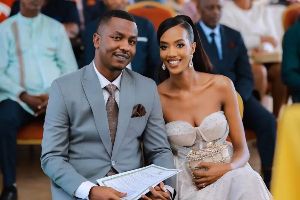 Dieudonne Ishimwe popularly known as Prince Kid and his wife, Miss Rwanda 2017 Iradukunda Elsa hold a wedding certificate  after making their vows  during a civil wedding ceremony in Rusororo Sector  in Kigali on Thursday, March 2. Courtesy