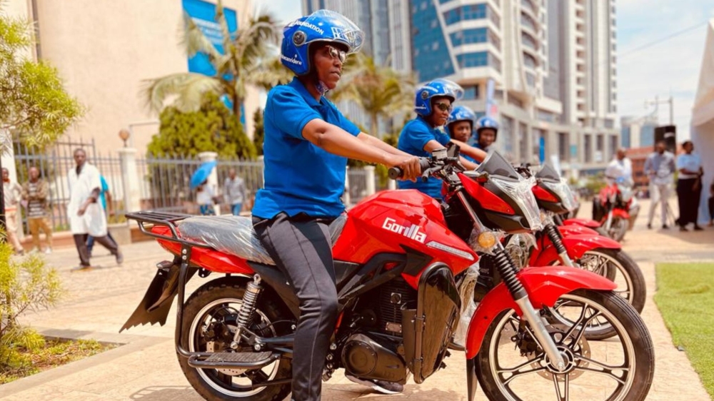 Some of the women beneficiaries of electric motorcycles offered by BK Foundation get ready to ride them at Kigali car-free zone, during the donation event on Friday, March 3, 2023. Photo by Emmanuel Ntirenganya