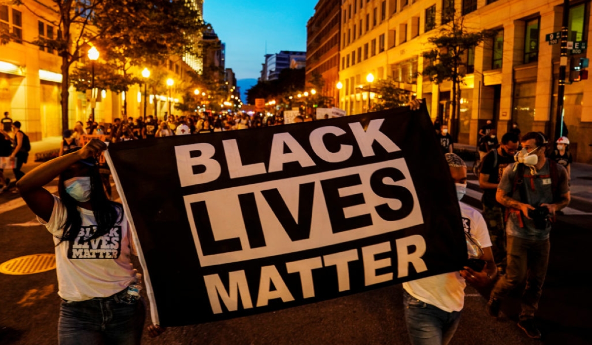 People hold up a Black Lives Matter banner as they march during a demonstration against racial inequality in the aftermath of the death in Minneapolis police custody of George Floyd, in Washington, U.S., June 14, 2020. REUTERS/Erin Scott