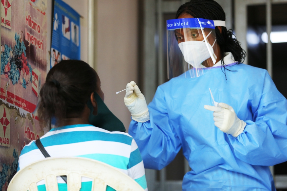 A health worker conducts Covid 19 testing exercise at Nyarugenge market in 2020. Dan Nsengiyumva