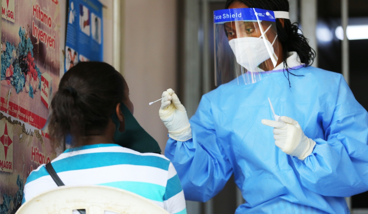 A health worker conducts Covid 19 testing exercise at Nyarugenge market in 2020. Dan Nsengiyumva