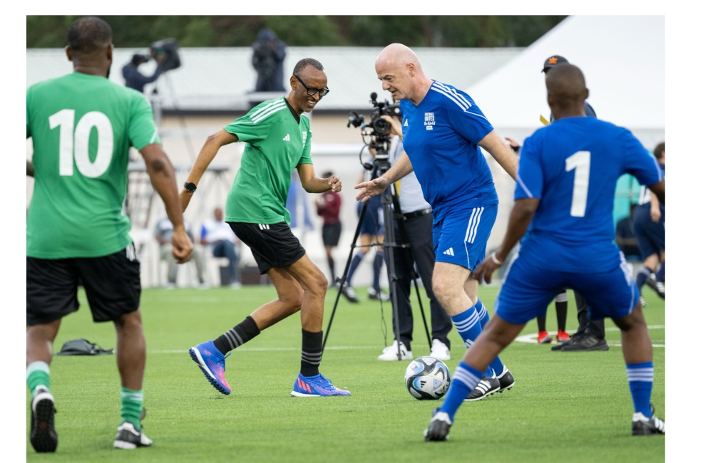 FIFA president Gianni Infantino controls the ball as he tries to go past President Paul Kagame during the match at the inauguration of Kigali Pele Stadium on March 15. Photo by Village Urugwiro 