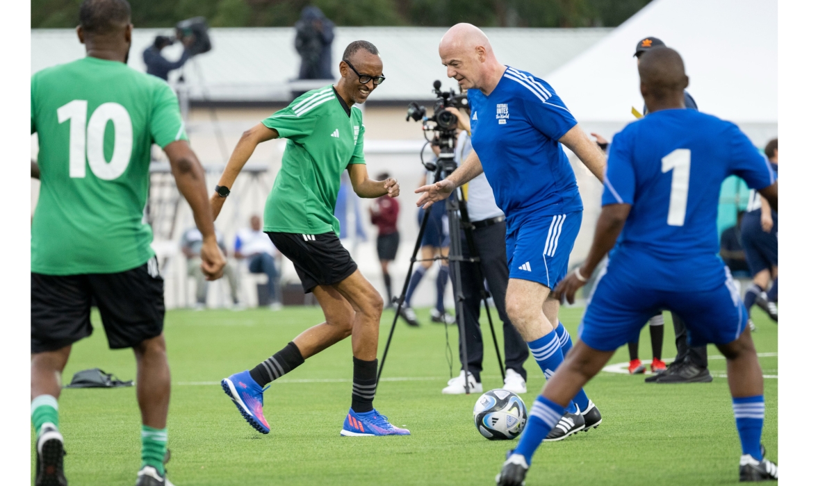FIFA president Gianni Infantino controls the ball as he tries to go past President Paul Kagame during the match at the inauguration of Kigali Pele Stadium on March 15. Photo by Village Urugwiro 