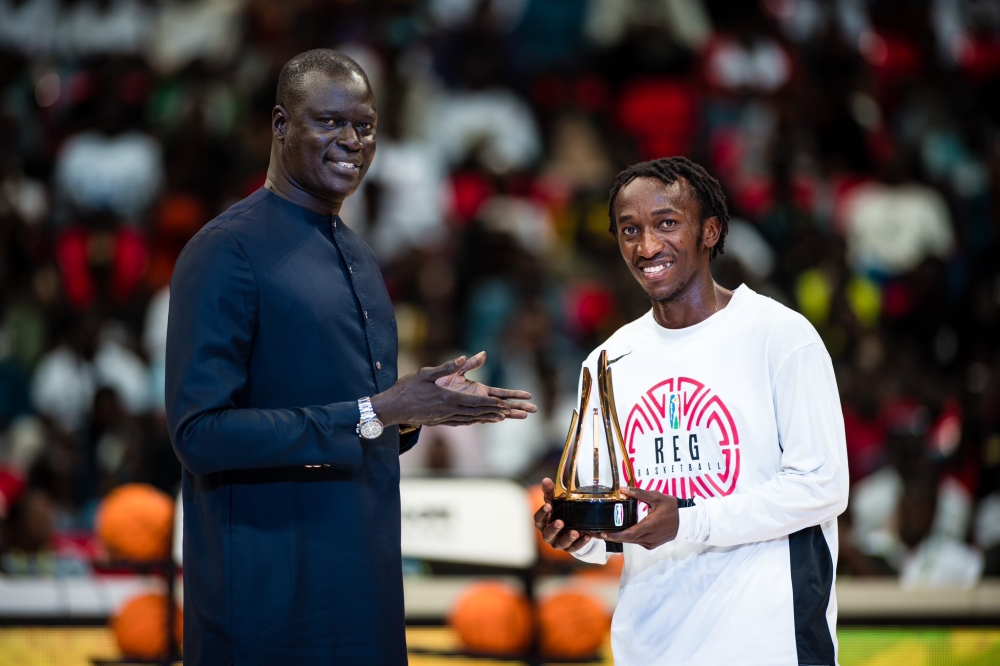 BAL President Amadou Gallo Fall awards &#039;Ubuntu&#039; Trophy&#039; to REG&#039; s point guard  Jean Jacques Nshobozwabyosenumukiza for his community service at Club Rafiki, in Dakar, Senegal on March 15. Courtesy