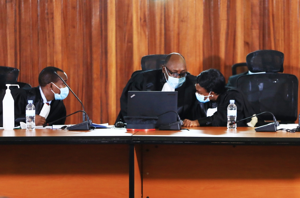 Judges consult one another during the hearing session of FLN trial. Sam Ngendahimana