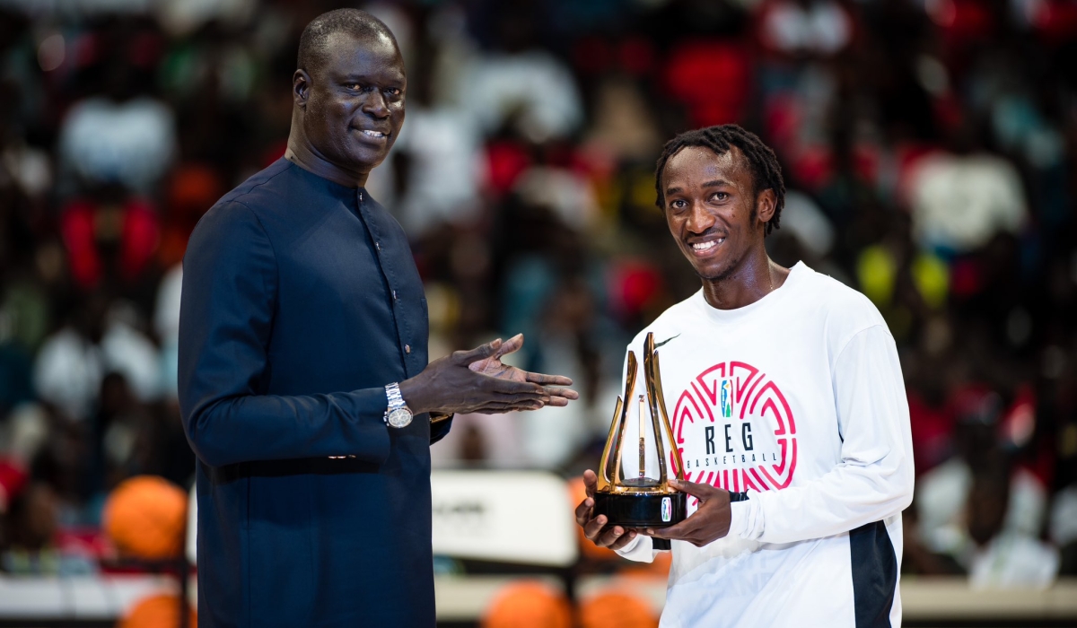 BAL President Amadou Gallo Fall awards &#039;Ubuntu&#039; Trophy&#039; to REG&#039; s point guard  Jean Jacques Nshobozwabyosenumukiza for his community service at Club Rafiki, in Dakar, Senegal on March 15. Courtesy