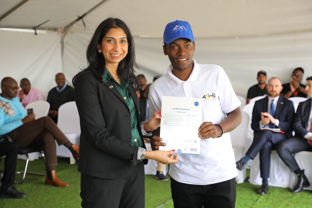 The UK Home Secretary, Suella Braverman presenting a certificate to one of the graduates of the first cohort at ADHI Technical, Vocational and Education Training (TVET) on Saturday, March 18. Photos by Craish Bahizi