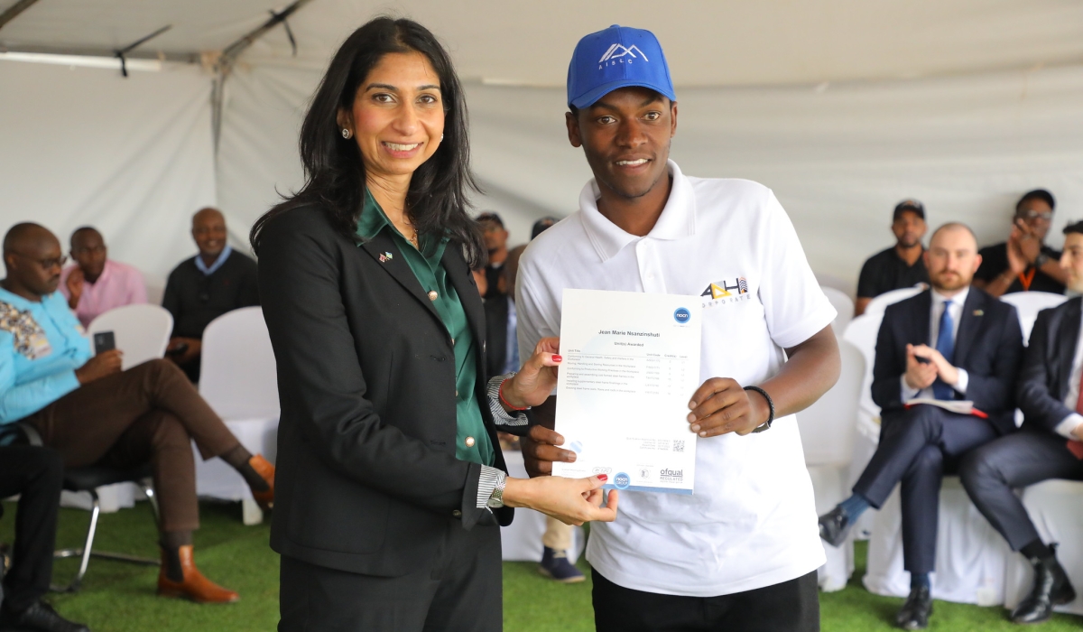 The UK Home Secretary, Suella Braverman presenting a certificate to one of the graduates of the first cohort at ADHI Technical, Vocational and Education Training (TVET) on Saturday, March 18. Photos by Craish Bahizi