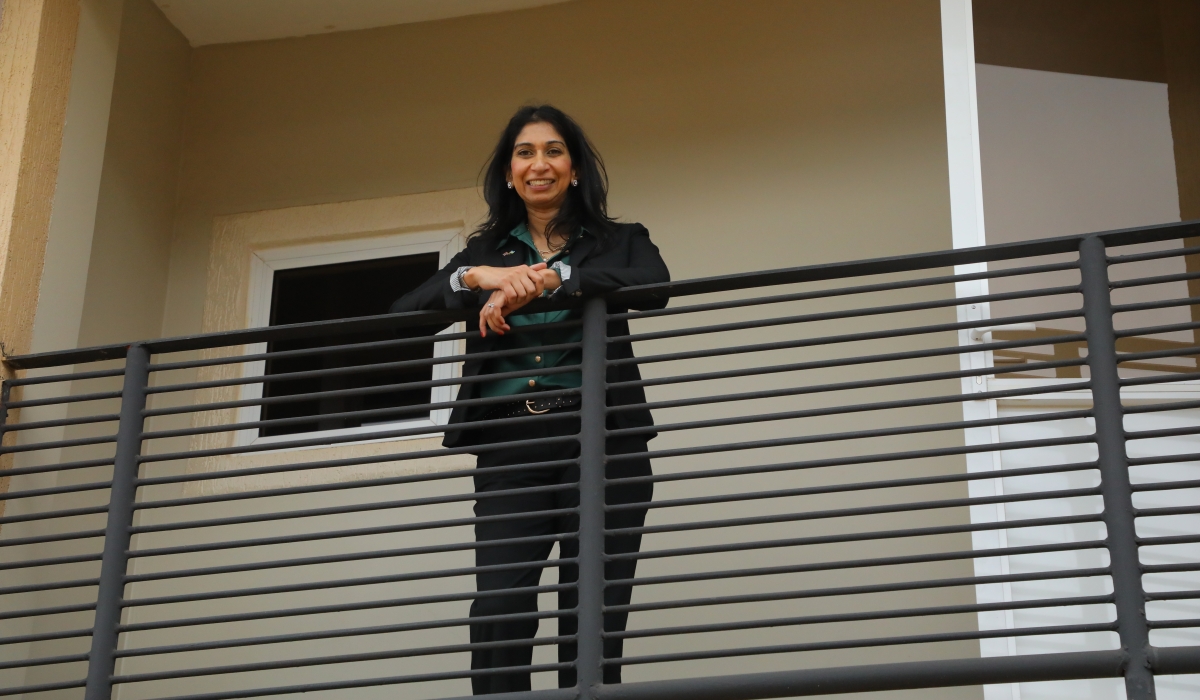 Suella Braverman, the UK Home Secretary, stands on the balcony of one of the houses that will host migrants evacuated from the United Kingdom. Craish Bahizi