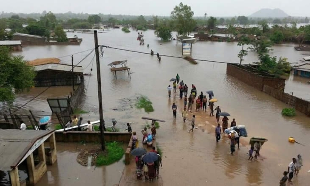 Residents wade through a flooded residential area in Mozambique last week. Internet