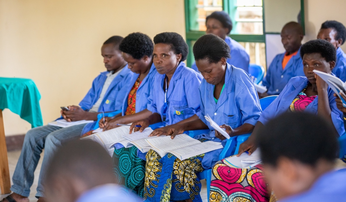 Community health worker gives advice to a couple at Mubuga Hospital in Karongi District. CHWs play a critical role in engaging communities in health initiatives. Photo by Olivier Mugwiza
