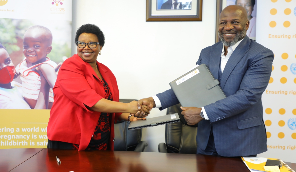 The President of Rwanda Association of Midwives, Josephine Murekezi, and UNFPA country representative, Kwabena Asante-Ntiamoah, during the signing ceremony in Kigali on March 23. Photos by Craish Bahizi