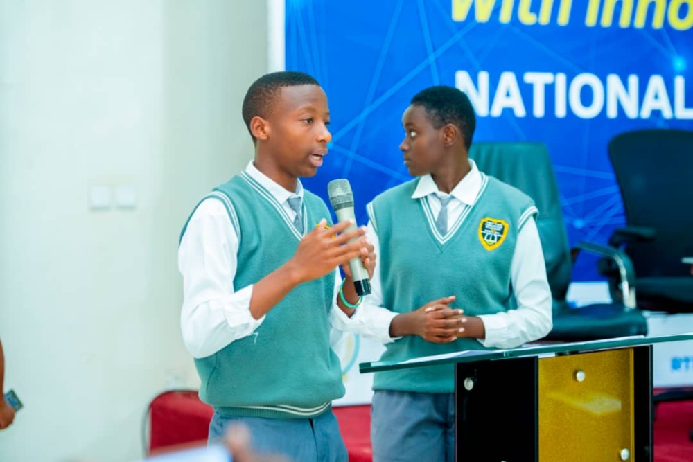 Emile Keza, a Senior five student at New Life Ministries Academy with his colleague presenting the project.