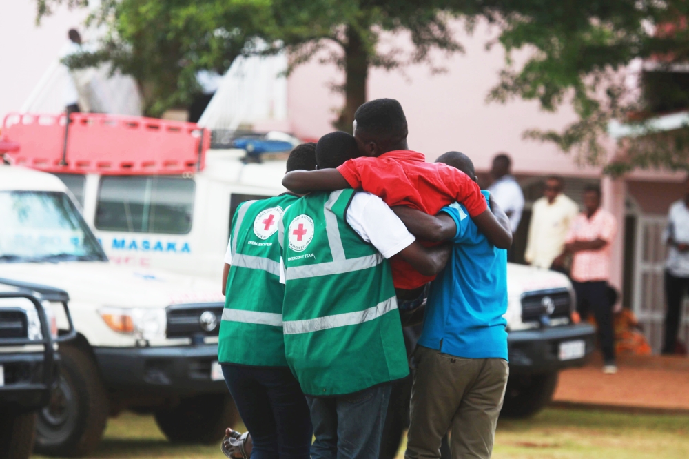 Volunteers help a trauma victim during a commemoration event at Nyanza-Kicukiro Genocide Memorial. Sam Ngendahimana