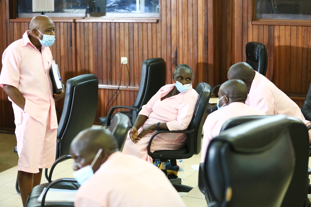 Paul Rusesabagina interacts with his co-accused at hearing session in Kigali on March 5, 2021. Sam Ngendahimana