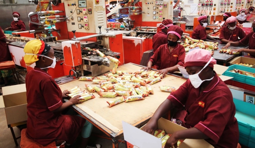 Workers pack biscuits at Adma International Ltd’s factory at Kigali Special Economic Zone in Gasabo District. Photo: Craish Bahizi