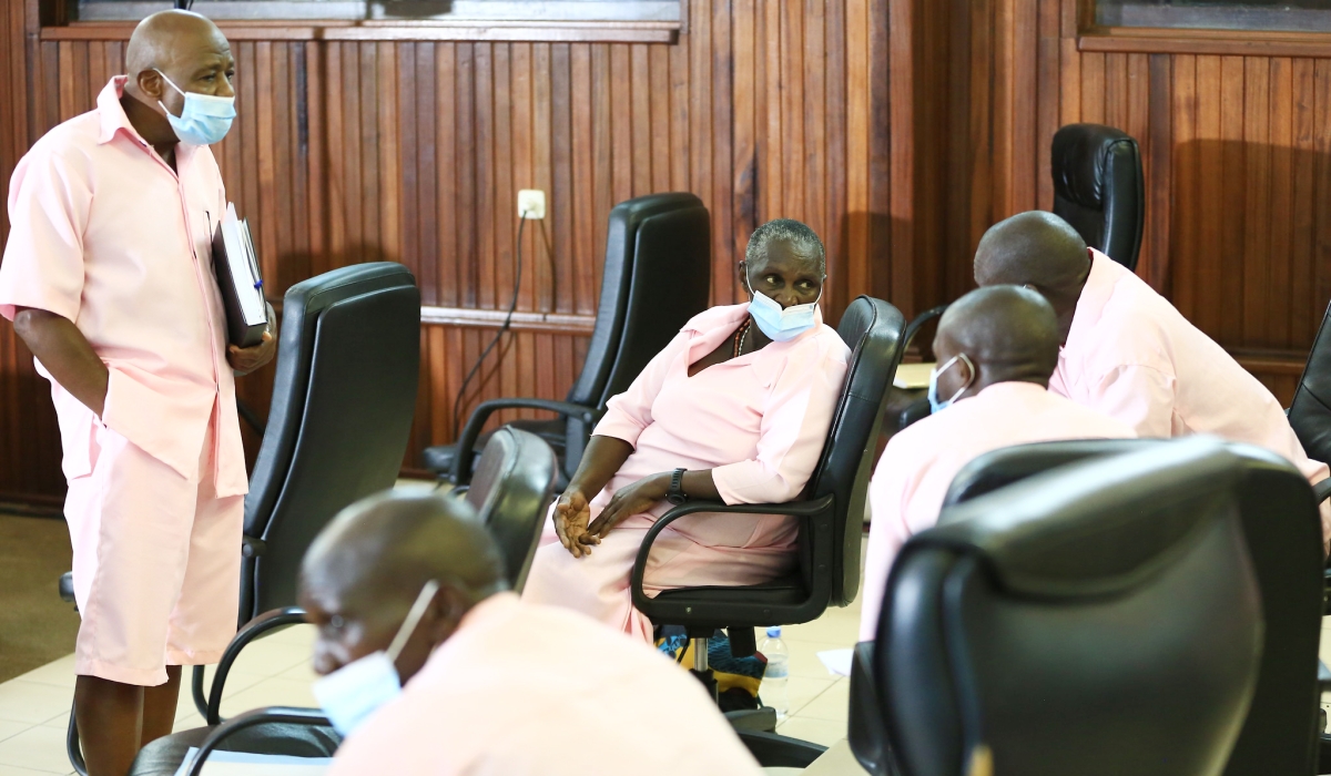 Paul Rusesabagina interacts with his co-accused at hearing session in Kigali on March 5, 2021. Sam Ngendahimana