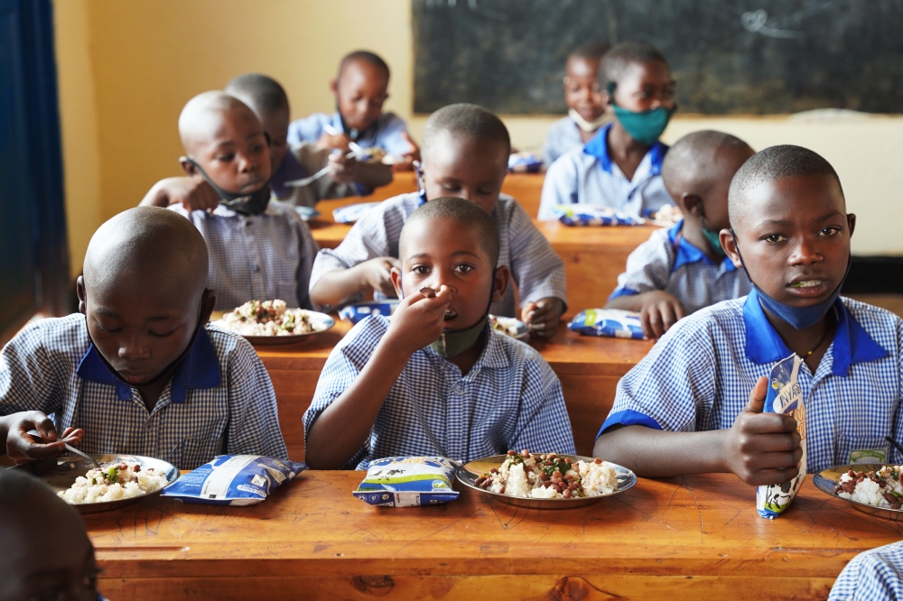 Students have  meal through school-feeding program at Groupe Scolaire Ayabaraya in Kicukiro District on Monday, February 28. Craish Bahizi