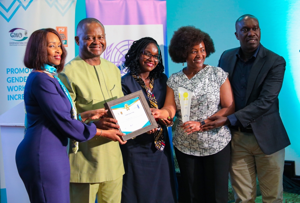 NCBA Rwanda Chief Executive Officer Lina Higiro(Left) receives the award as the bank got recognised by the Rwanda Gender Monitoring Office for establishing a gender-equal working environment in the workplace. All photos by Dan Gatsinzi