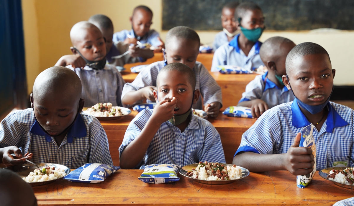 Students have  meal through school-feeding program at Groupe Scolaire Ayabaraya in Kicukiro District on Monday, February 28. Craish Bahizi