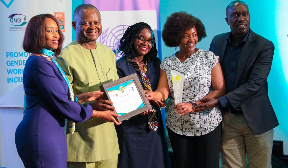 NCBA Rwanda Chief Executive Officer Lina Higiro(Left) receives the award as the bank got recognised by the Rwanda Gender Monitoring Office for establishing a gender-equal working environment in the workplace. All photos by Dan Gatsinzi
