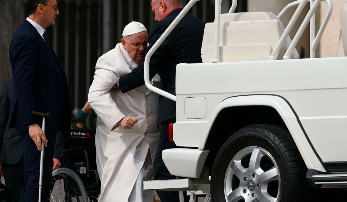 Pope Francis is helped on March 29, 2023 to get up the popemobile car as he leaves at the end of the weekly general audience The Vatican. Photo: AFP