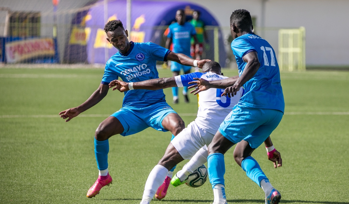 Rayon Sports player tries to go past Police FC defenders during a past game. Rayon Sports have an uphill task to beat Police FC on Saturday, April 1, to keep pressure on title rivals APR. Photo by Olivier Mugwiza