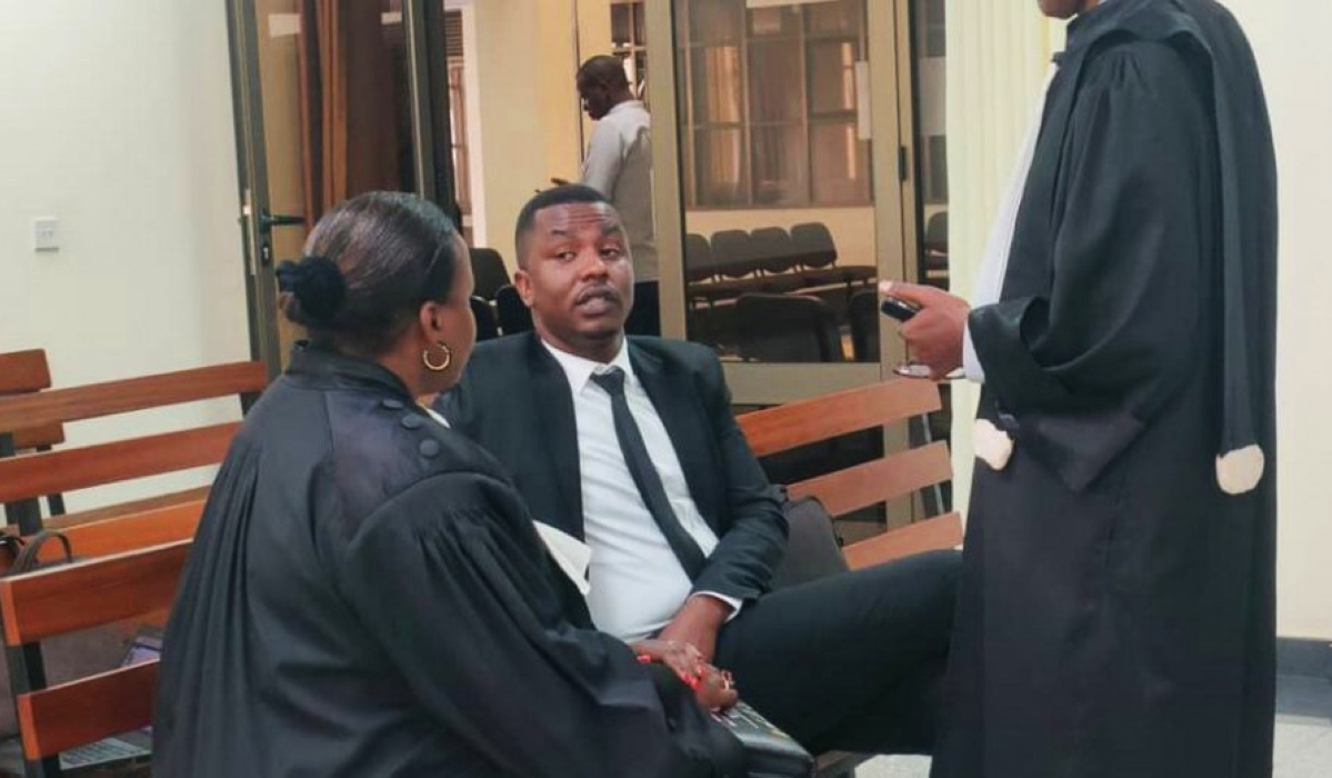 Dieudonnee Ishimwe,popularly known as "Prince Kid", the organizer of the Miss Rwanda beauty pageant, consults with his lawyers at a hearing session on Friday, March 31. Courtesy
