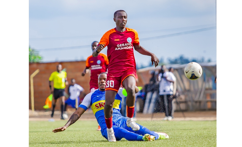 The Blues defender Aboul Rwatubyaye in action as he tries to gain the ball from Police Fc&#039;s player  at Muhanga Stadium on Saturday, April 1. Police FC beat Rayon Sports 4-2. Courtesy 