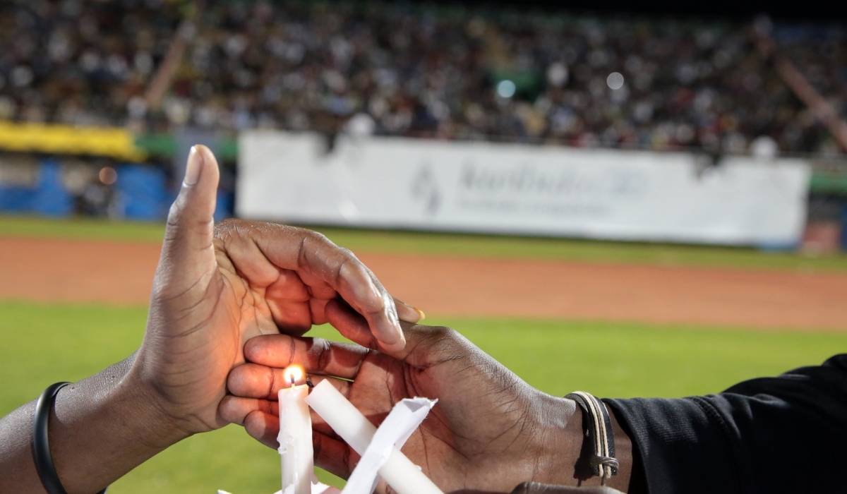 Mourners light a candle during a past Genocide commemoration event. According to the Ministry of National Unity and Civic Engagement, the upcoming Genocide commemoration will be held under the recurring theme ‘Kwibuka Twiyubaka’, or ‘Remember-Unite-Renew’.