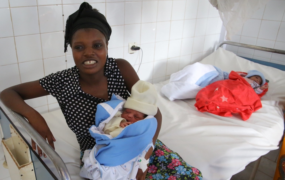 A woman holds her baby after giving birth at Kacyiru Hospital on January 1, 2022. Craish Bahizi